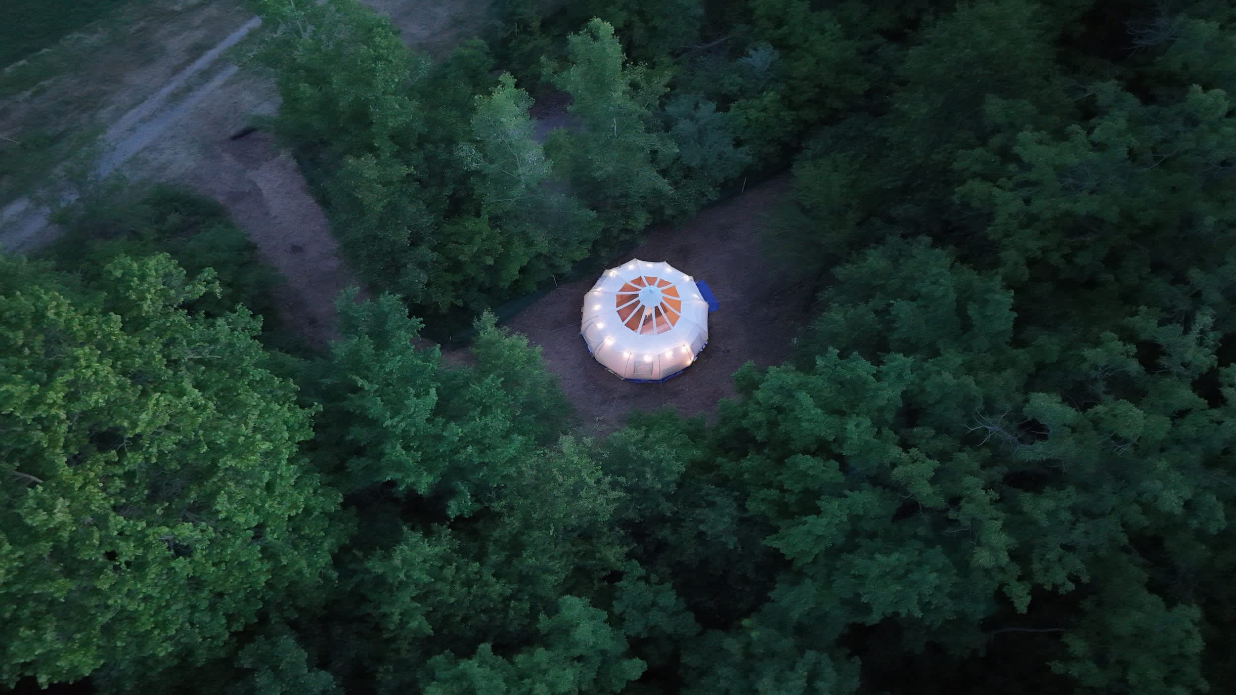 Aerial view of a glamping tent among trees at Hungry World Farm