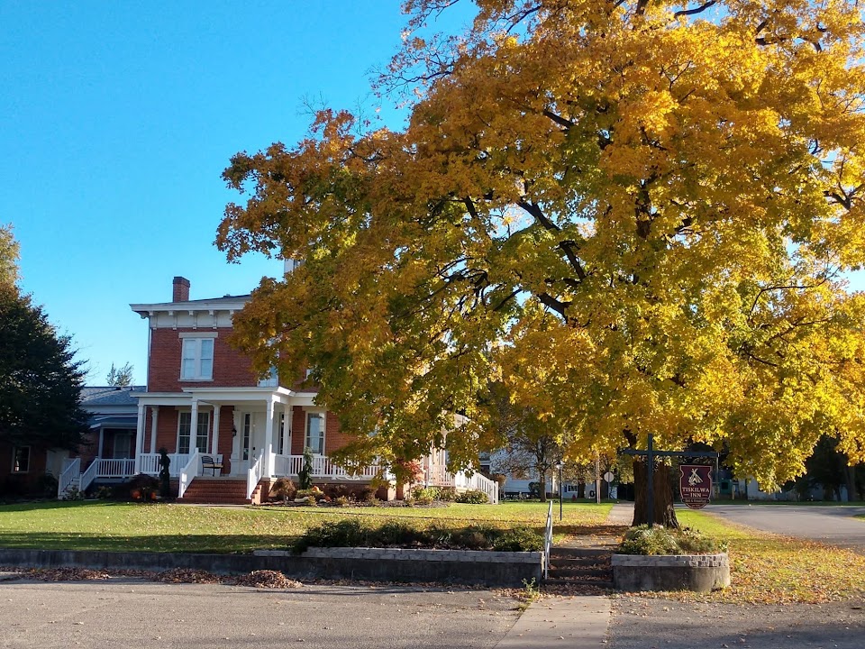 The Tiskilwa Inn behind golden autumn foliage