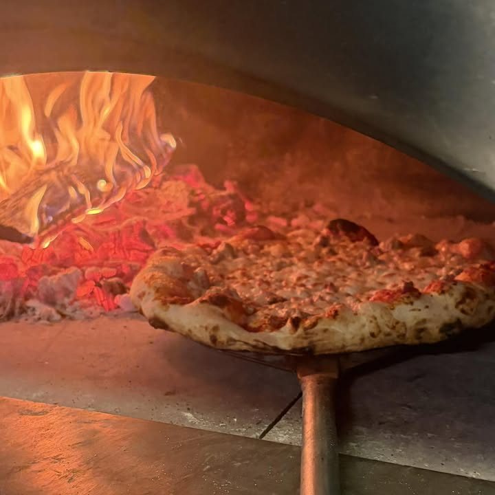 Pizza baking in the wood-fired oven at Sticks and Bricks