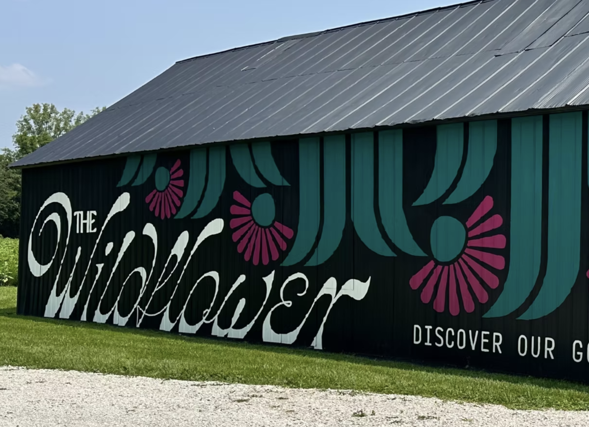 The Wildflower’s colorful floral mural on a black barn